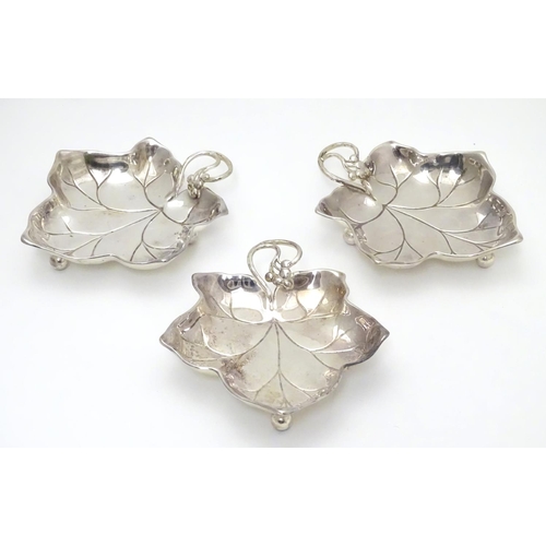 414 - Three WMF silver plated leaf-form pickle dishes with berry detail, each raised on three bun feet. WM... 