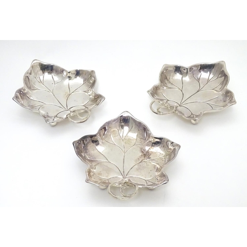 414 - Three WMF silver plated leaf-form pickle dishes with berry detail, each raised on three bun feet. WM... 