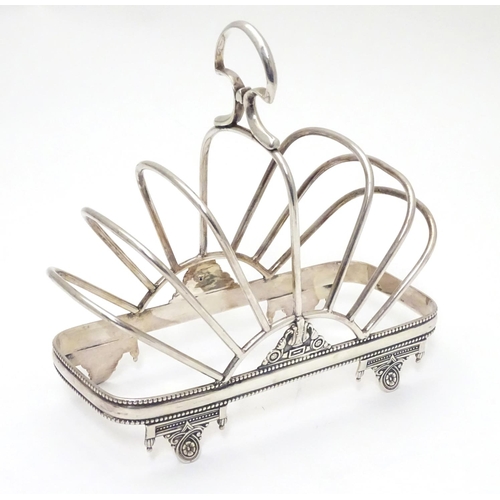 417 - A silver plate 7 bar toast / letter rack  with loop handle. Indistinctly marked with registration di... 