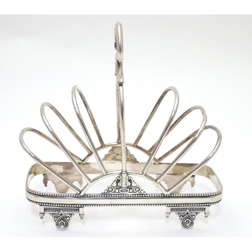 417 - A silver plate 7 bar toast / letter rack  with loop handle. Indistinctly marked with registration di... 