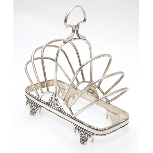 417 - A silver plate 7 bar toast / letter rack  with loop handle. Indistinctly marked with registration di... 