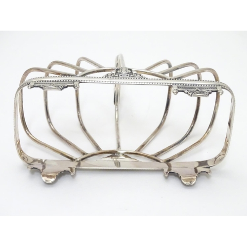 417 - A silver plate 7 bar toast / letter rack  with loop handle. Indistinctly marked with registration di... 