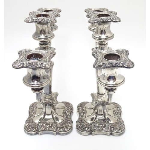 418 - A pair of silver plate candelabra with fruiting vine decoration . Approx 10