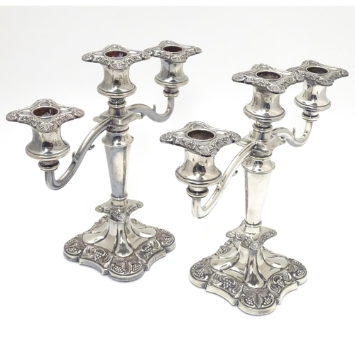 418 - A pair of silver plate candelabra with fruiting vine decoration . Approx 10