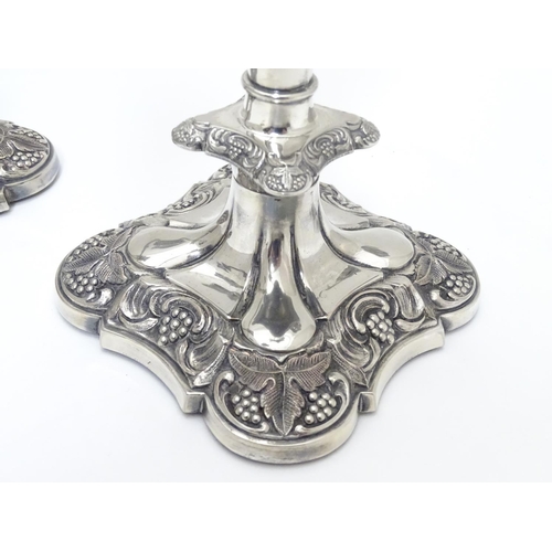 418 - A pair of silver plate candelabra with fruiting vine decoration . Approx 10