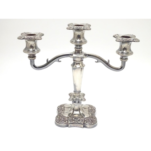 418 - A pair of silver plate candelabra with fruiting vine decoration . Approx 10