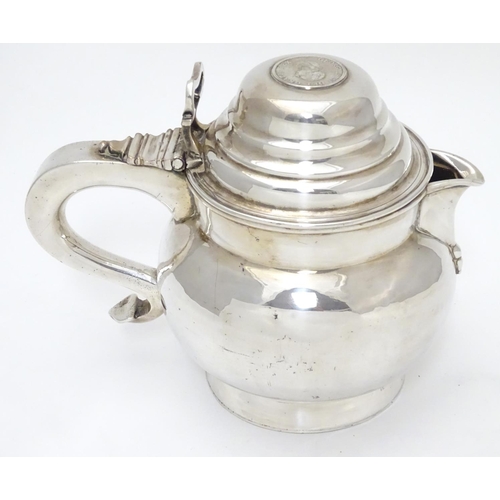 419 - An unusual silver plate jug having hinged lid set with faux Geo III coin and engraved armorial to si... 