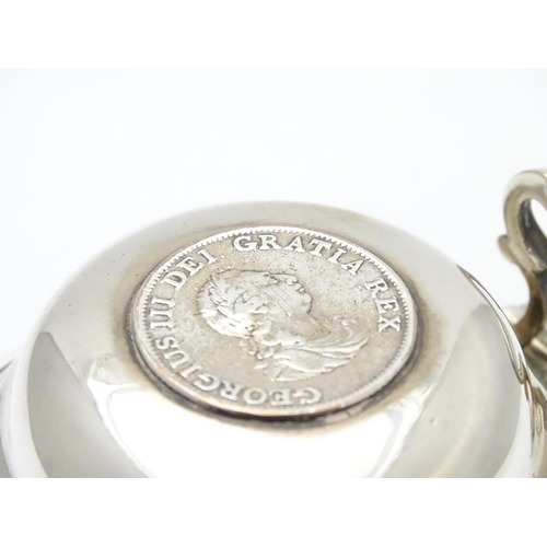 419 - An unusual silver plate jug having hinged lid set with faux Geo III coin and engraved armorial to si... 