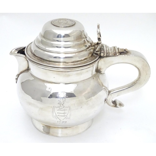 419 - An unusual silver plate jug having hinged lid set with faux Geo III coin and engraved armorial to si... 