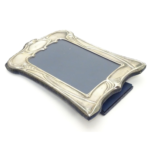 422 - A photograph frame with silver surround having Art Nouveau style decoration. Hallmarked Sheffield 19... 