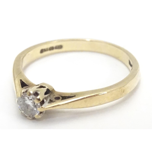 447 - A 9ct gold ring set with diamond solitaire. The diamond approx 1/8