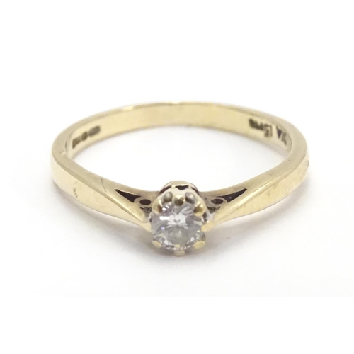 447 - A 9ct gold ring set with diamond solitaire. The diamond approx 1/8