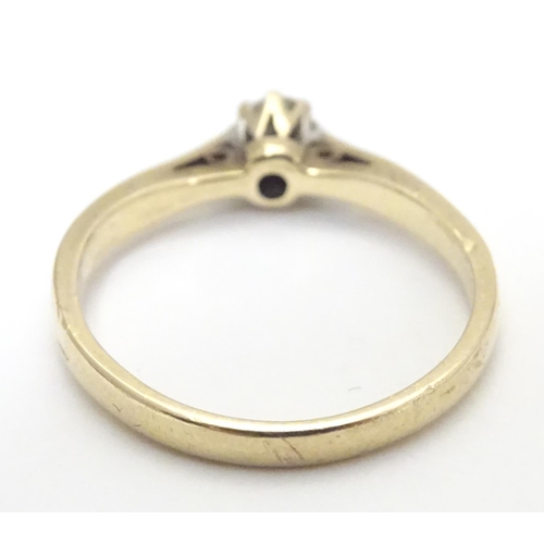 447 - A 9ct gold ring set with diamond solitaire. The diamond approx 1/8