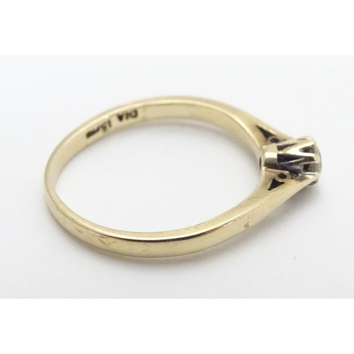 447 - A 9ct gold ring set with diamond solitaire. The diamond approx 1/8