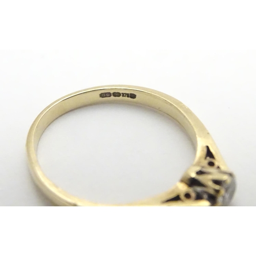 447 - A 9ct gold ring set with diamond solitaire. The diamond approx 1/8