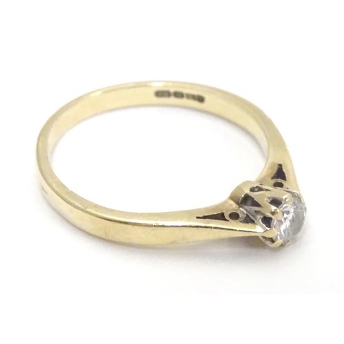 447 - A 9ct gold ring set with diamond solitaire. The diamond approx 1/8