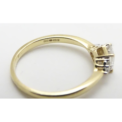 449 - A 9ct gold ring set with cubic zirconia. Ring size approx M