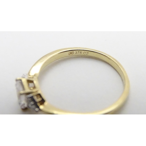 449 - A 9ct gold ring set with cubic zirconia. Ring size approx M