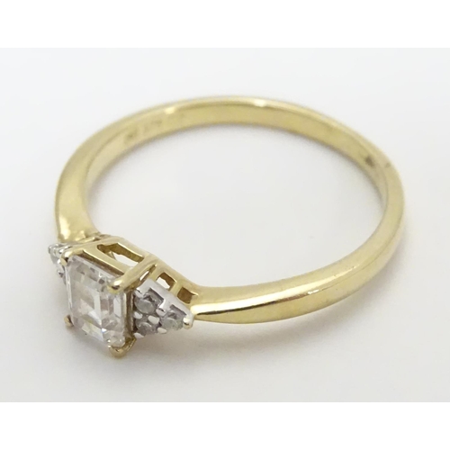 449 - A 9ct gold ring set with cubic zirconia. Ring size approx M