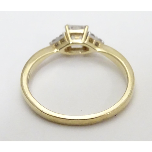 449 - A 9ct gold ring set with cubic zirconia. Ring size approx M