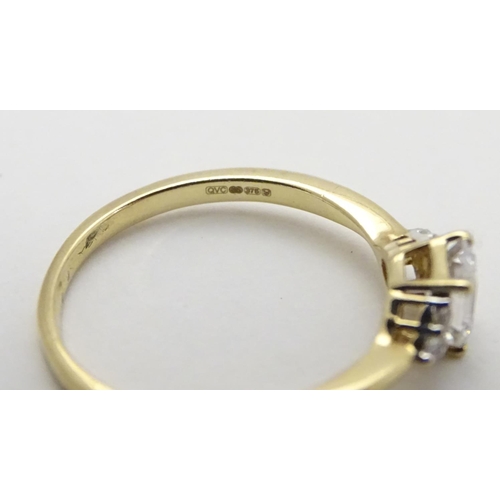 449 - A 9ct gold ring set with cubic zirconia. Ring size approx M