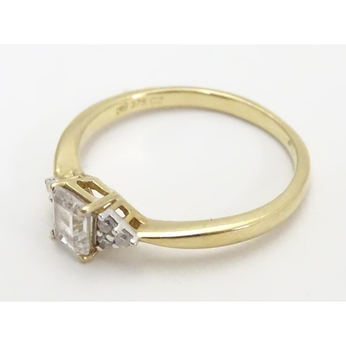 449 - A 9ct gold ring set with cubic zirconia. Ring size approx M