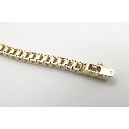 466 - A 9ct gold bracelet set with a band of white stones. Approx 7