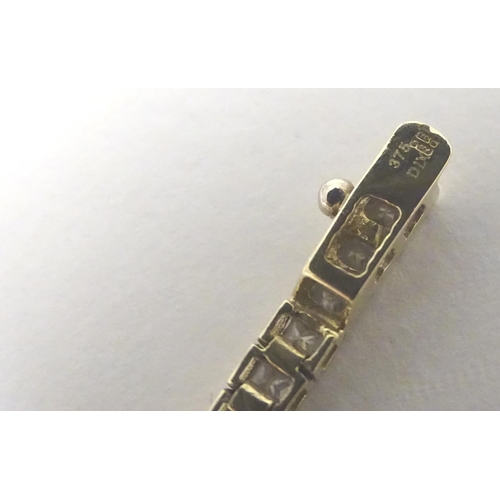 466 - A 9ct gold bracelet set with a band of white stones. Approx 7