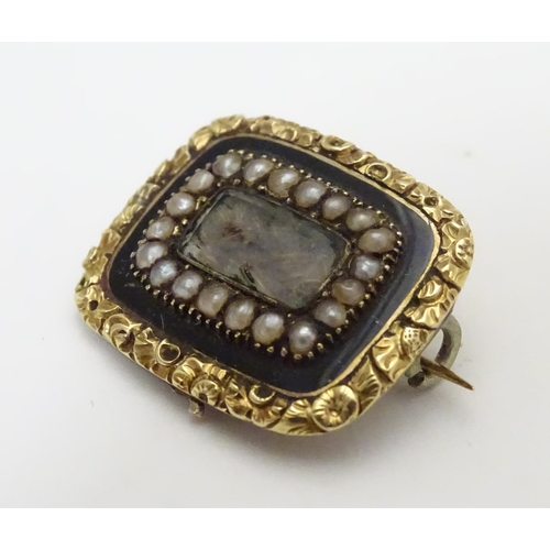 469 - Mourning / Memorial jewellery :  A 19thC yellow metal memorial brooch, the central glazed panel cont... 