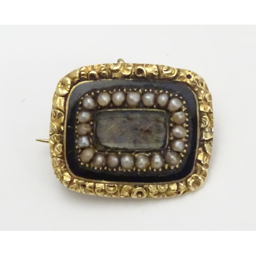 469 - Mourning / Memorial jewellery :  A 19thC yellow metal memorial brooch, the central glazed panel cont... 