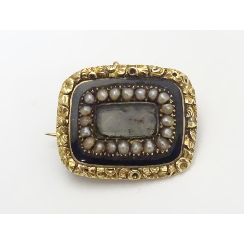 469 - Mourning / Memorial jewellery :  A 19thC yellow metal memorial brooch, the central glazed panel cont... 