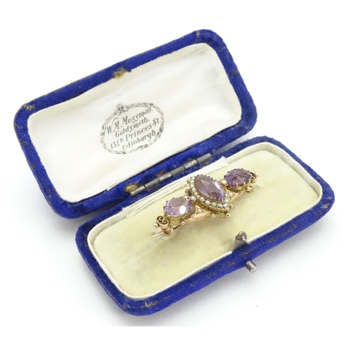 473 - A Victorian brooch set with facet cut amethyst and seed pearls 1 1/2