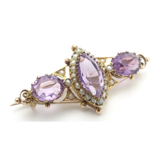 473 - A Victorian brooch set with facet cut amethyst and seed pearls 1 1/2