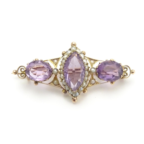 473 - A Victorian brooch set with facet cut amethyst and seed pearls 1 1/2