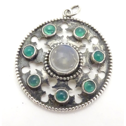 474 - An Arts & Crafts white metal pendant set with central moonstone cabochon bordered by green stone cab... 