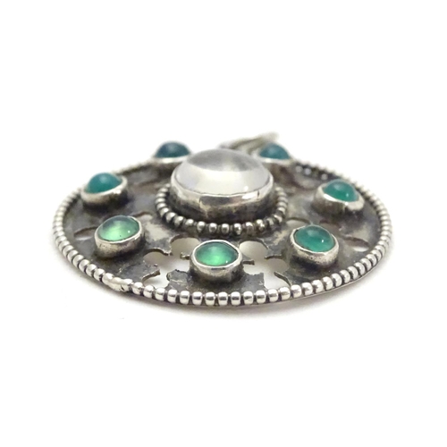 474 - An Arts & Crafts white metal pendant set with central moonstone cabochon bordered by green stone cab... 