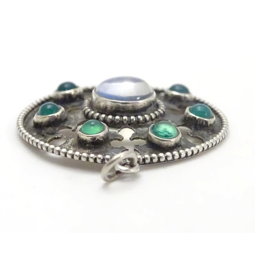 474 - An Arts & Crafts white metal pendant set with central moonstone cabochon bordered by green stone cab... 