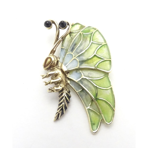 476 - A 14ct gold pendant formed as a butterfly with plique a jour detail to wings. 1 1/2