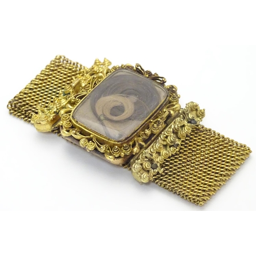 477 - Mourning / Memorial jewellery : A 19thC gilt metal mourning bracelet of cuff form with wide chain li... 