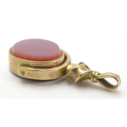 480 - A late 19thC / early 20thC 10ct gold pendant fob seal with rotating central seal section set with bl... 