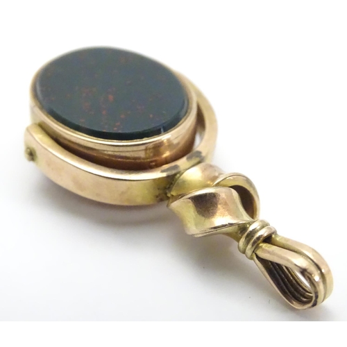 480 - A late 19thC / early 20thC 10ct gold pendant fob seal with rotating central seal section set with bl... 