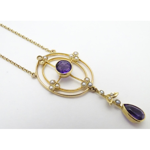 493 - A 15ct gold pendant and chain, the pendant with amethyst and seed pearl decoration. Approx. 19