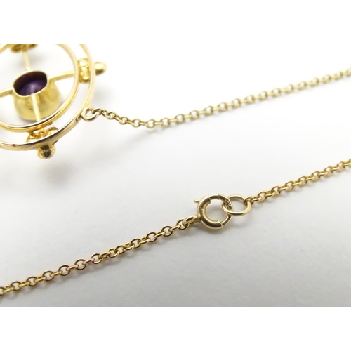 493 - A 15ct gold pendant and chain, the pendant with amethyst and seed pearl decoration. Approx. 19