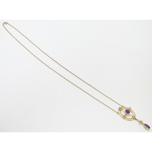 493 - A 15ct gold pendant and chain, the pendant with amethyst and seed pearl decoration. Approx. 19