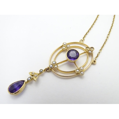 493 - A 15ct gold pendant and chain, the pendant with amethyst and seed pearl decoration. Approx. 19