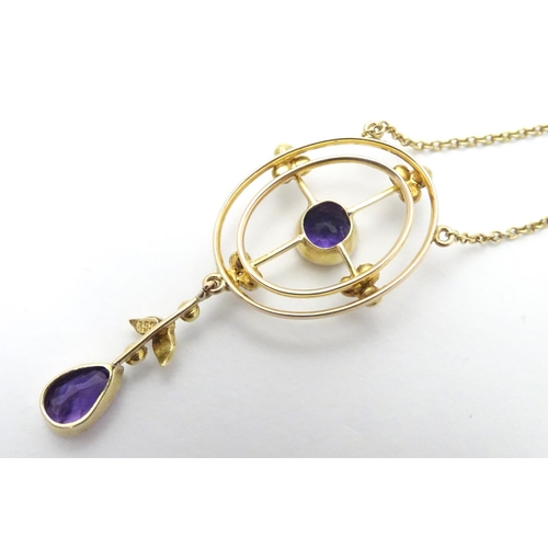 493 - A 15ct gold pendant and chain, the pendant with amethyst and seed pearl decoration. Approx. 19