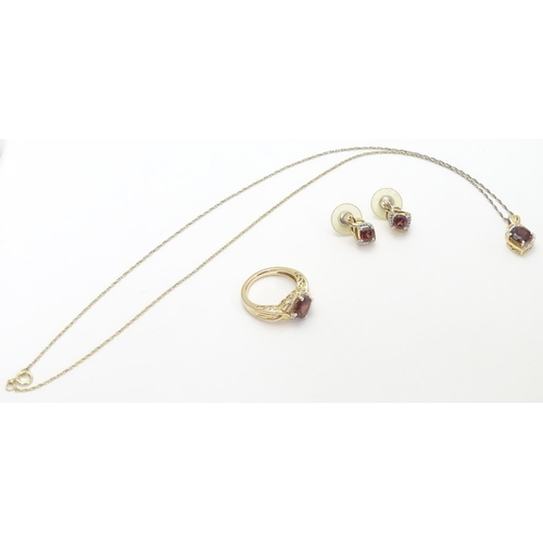 498 - A suite of silver gilt jewellery comprising ring, pendant on chain and stud earrings, each set with ... 