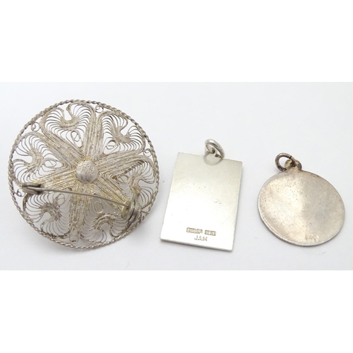 502 - Two silver pendants comprising a St Christopher of rectangular form stamped Sterling Silver, JAM, an... 