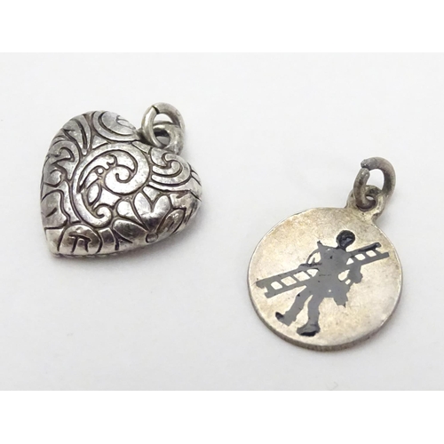 507 - Two pendant charms, one f heart form, the other circular with silhouette decoration. Each approx. 1/... 