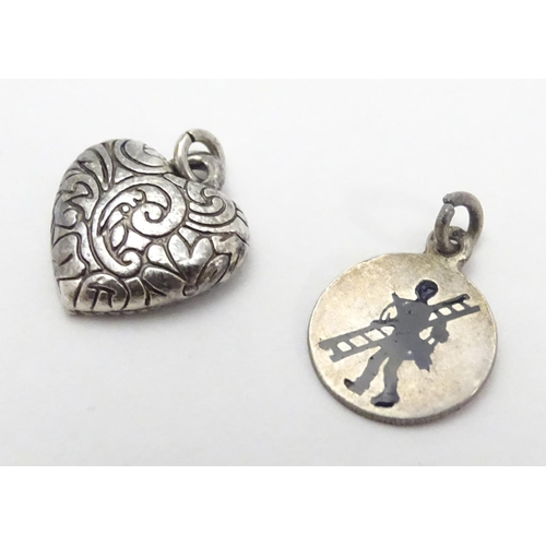 507 - Two pendant charms, one f heart form, the other circular with silhouette decoration. Each approx. 1/... 